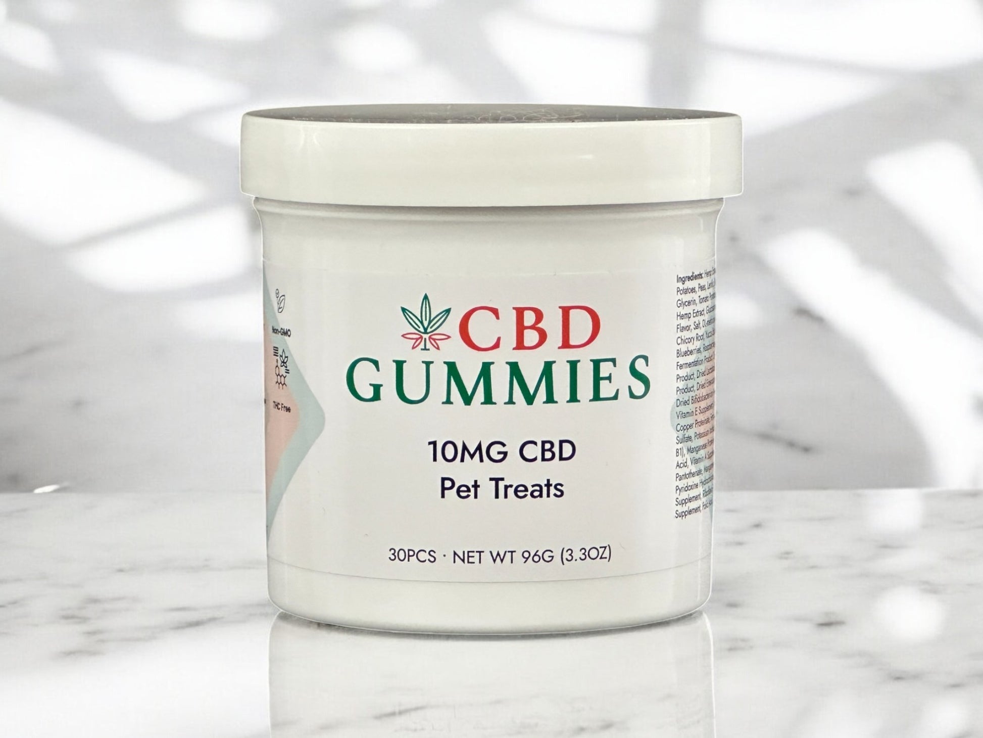 Jar of CBD Gummies for pets on a marble surface with a blurred background