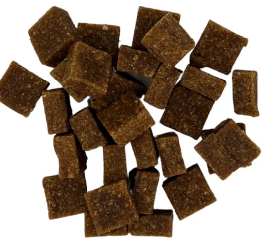 Brown square-shaped pet treats on a white background